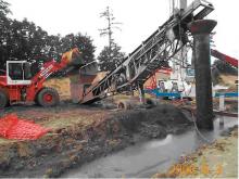 Biopolymer trenching, fillling of iron/sand using a tremie pipe